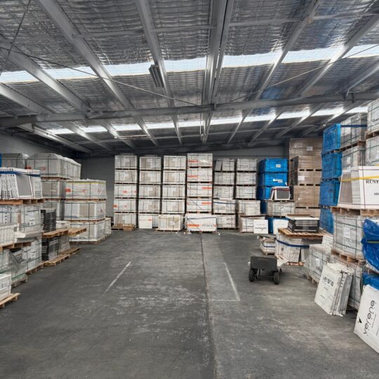 Verona Ceramic warehouse with stacked boxes of tiles and flooring materials.