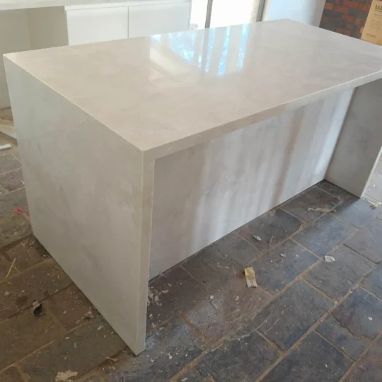 Modern kitchen with engineered stone benchtop and tiles.