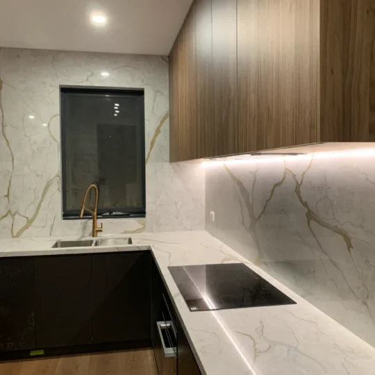 Modern kitchen featuring marble-effect tiles and timber cabinetry, Verona Ceramic project gallery example.