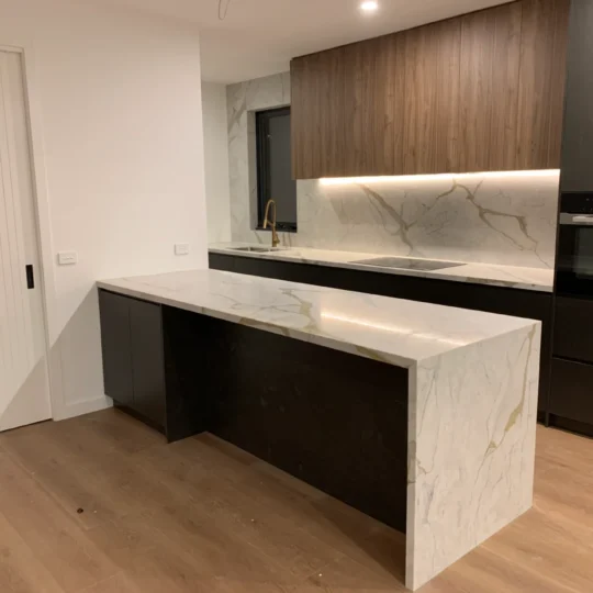 Modern kitchen renovation featuring marble-effect tiles and engineered stone benchtop.