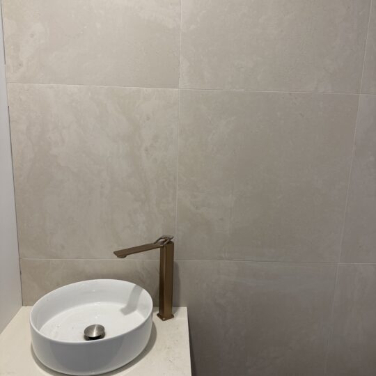 Bathroom wall tiles and basin showcasing Verona Ceramic tile installation.