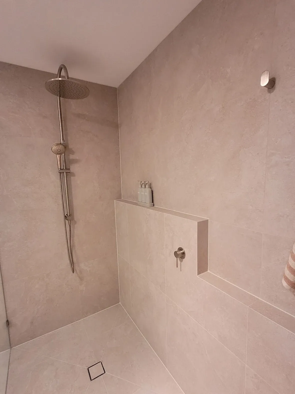 Stylish bathroom renovation with Verona Ceramic tiles and modern shower fixtures.